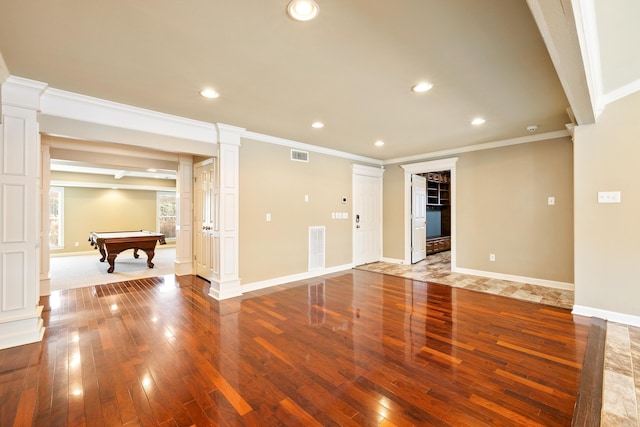 interior space with visible vents, ornate columns, and hardwood / wood-style flooring