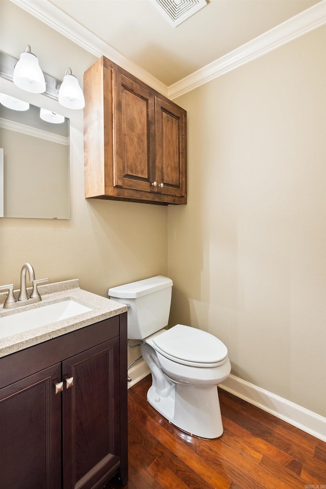 bathroom featuring toilet, wood finished floors, visible vents, and crown molding