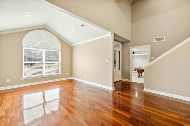 unfurnished living room with wood finished floors, visible vents, and baseboards