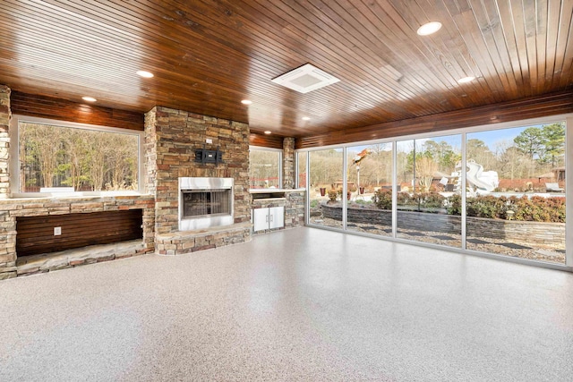 unfurnished living room featuring recessed lighting, wooden ceiling, a fireplace, and speckled floor