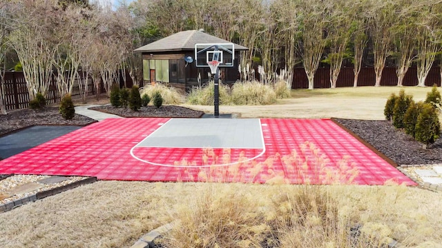 view of sport court with fence and basketball hoop