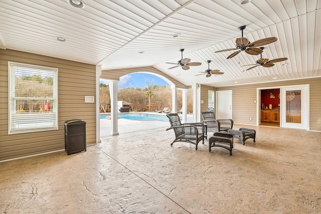 view of patio with a ceiling fan and an outdoor pool