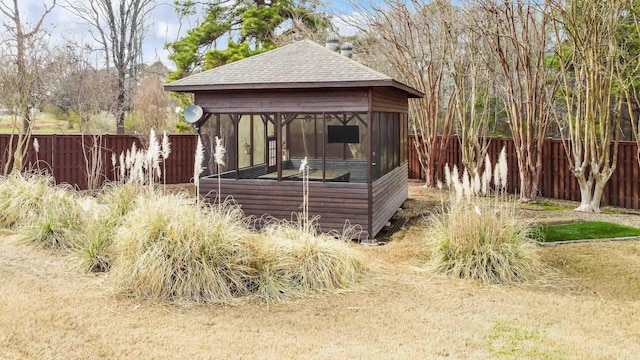 exterior space with a fenced backyard and a gazebo