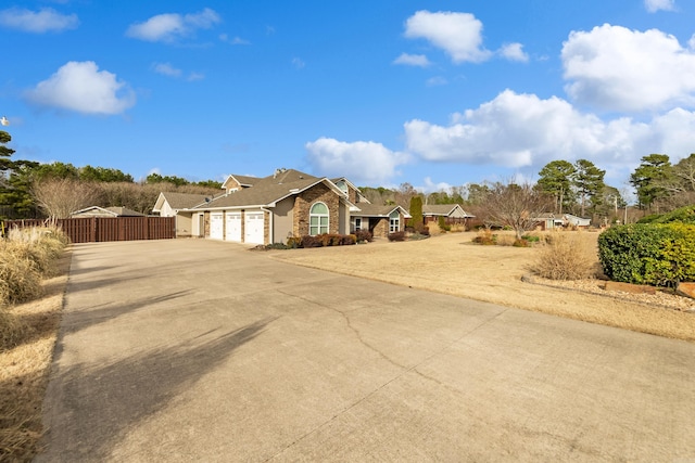 exterior space with a garage, driveway, and fence