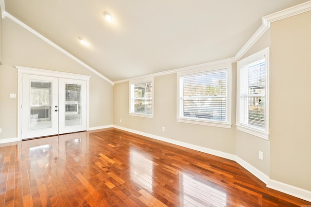 spare room with french doors, ornamental molding, vaulted ceiling, wood finished floors, and baseboards