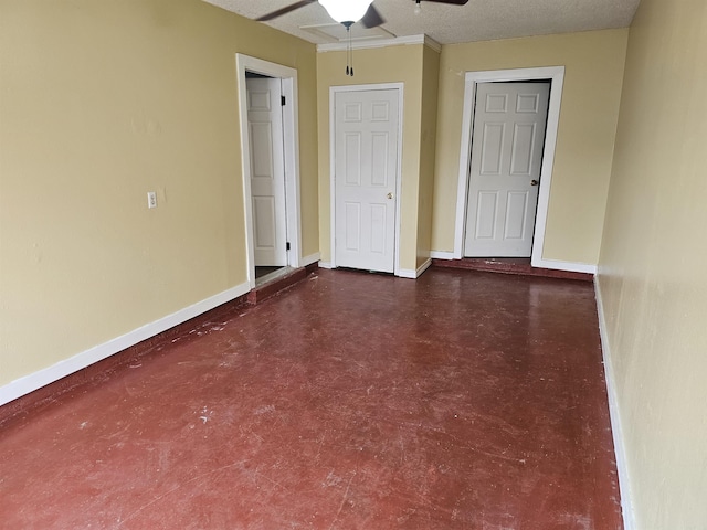 spare room featuring a ceiling fan, baseboards, and a textured ceiling