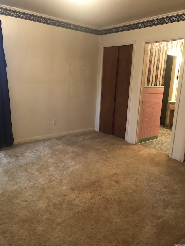 unfurnished bedroom with a closet and carpet flooring