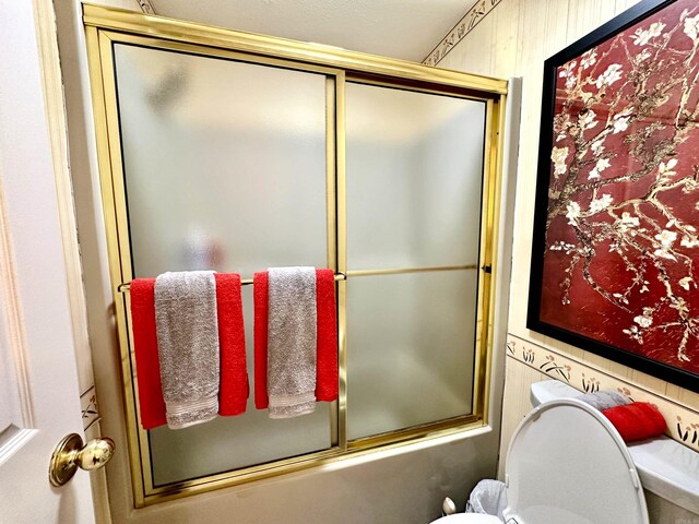 312 State St, Dardanelle, AR 72834 - bathroom featuring bath / shower combo with glass door and toilet