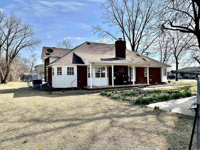 312 State St, Dardanelle, AR 72834 - view of front facade featuring a porch, a front yard, and a chimney