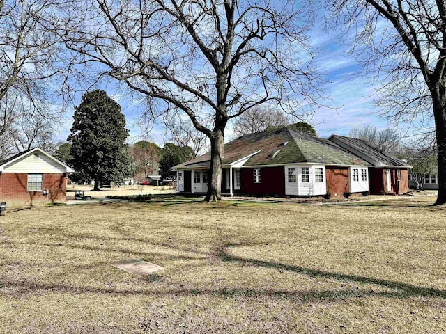 312 State St, Dardanelle, AR 72834 - view of side of home with a lawn