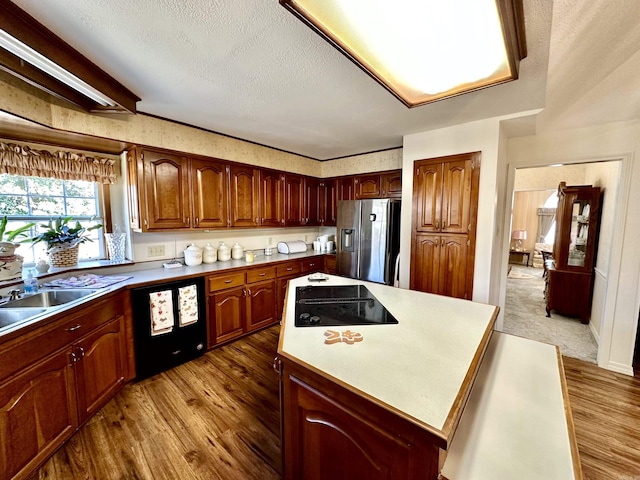 312 State St, Dardanelle, AR 72834 - kitchen with dark wood-style floors, a center island, light countertops, a textured ceiling, and black appliances