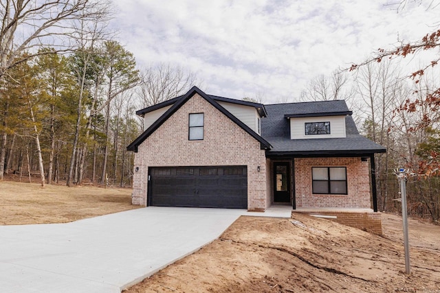 traditional-style home featuring a garage, driveway, brick siding, and a shingled roof