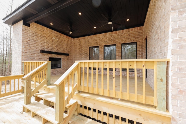 exterior space featuring ceiling fan, a deck, and brick siding