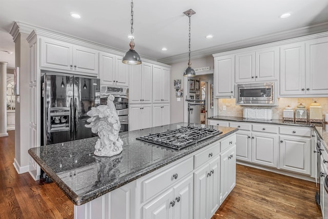 kitchen featuring dark wood-style floors, stainless steel appliances, tasteful backsplash, and white cabinets