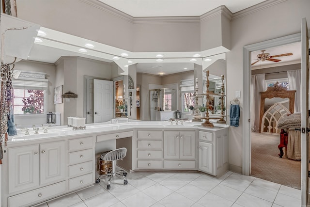 bathroom featuring double vanity, ornamental molding, and a sink