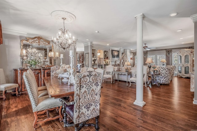 dining room featuring ornamental molding, wood finished floors, decorative columns, and ceiling fan with notable chandelier