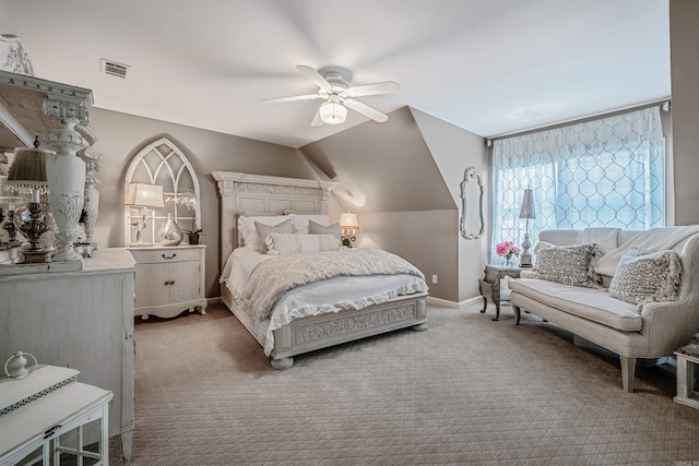 carpeted bedroom with lofted ceiling, baseboards, visible vents, and a ceiling fan