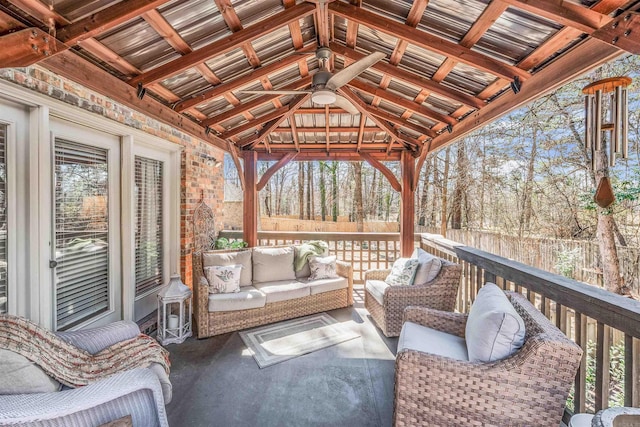 wooden deck featuring fence, an outdoor living space, and a gazebo