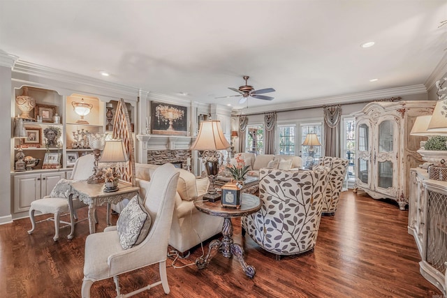 living area featuring crown molding, a fireplace, recessed lighting, ceiling fan, and wood finished floors