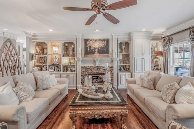 living area with crown molding, a fireplace, dark wood finished floors, and a ceiling fan