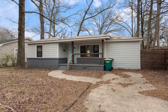 single story home with a porch, crawl space, brick siding, and fence