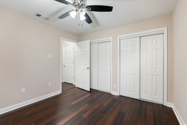 3215 Katherine St, Little Rock, AR 72204 - unfurnished bedroom with visible vents, dark wood finished floors, baseboards, and two closets