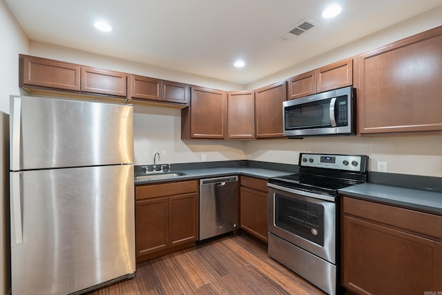 3215 Katherine St, Little Rock, AR 72204 - kitchen with appliances with stainless steel finishes, dark countertops, a sink, and visible vents