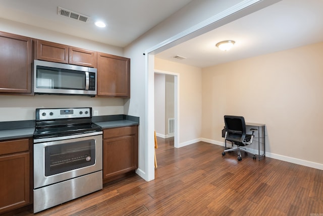 3215 Katherine St, Little Rock, AR 72204 - kitchen with dark countertops, visible vents, stainless steel appliances, and dark wood finished floors