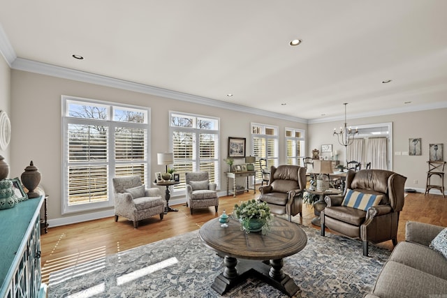 living area with crown molding, baseboards, a notable chandelier, and wood finished floors