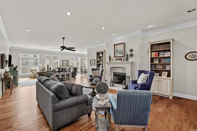 living room with a fireplace with flush hearth, recessed lighting, baseboards, and wood finished floors