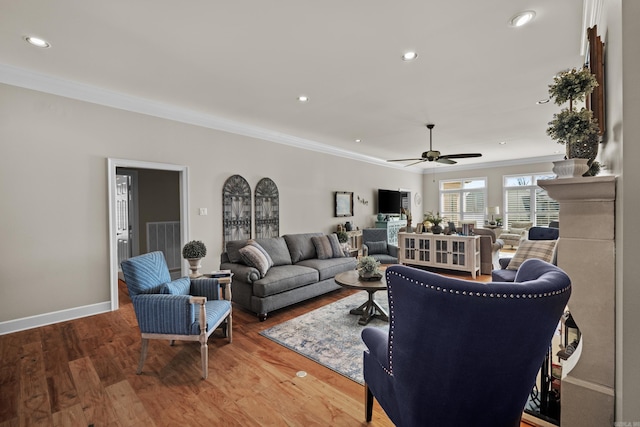 living area featuring baseboards, recessed lighting, wood finished floors, and crown molding