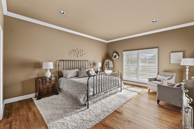 bedroom featuring baseboards, ornamental molding, wood finished floors, and recessed lighting