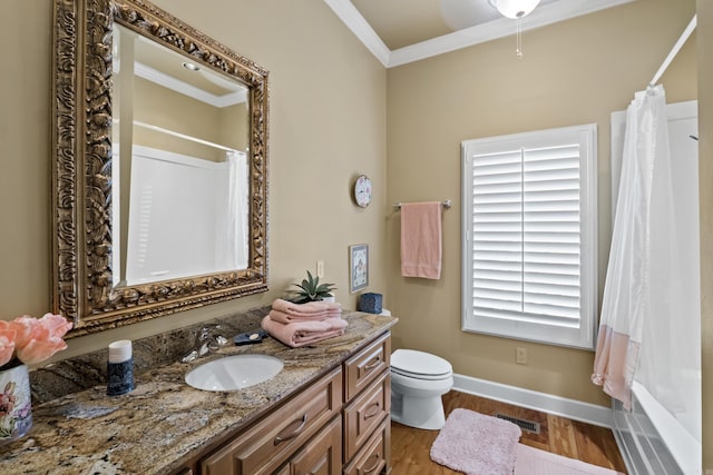 full bath featuring visible vents, ornamental molding, vanity, wood finished floors, and baseboards