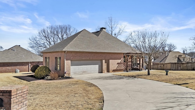 view of front of property with a garage, driveway, brick siding, and fence