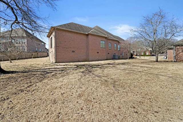 back of property featuring crawl space, central air condition unit, fence, and brick siding