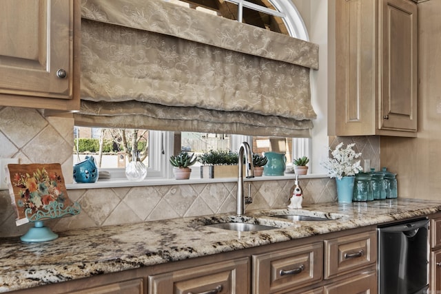 kitchen featuring dishwashing machine, light stone countertops, a sink, backsplash, and brown cabinets