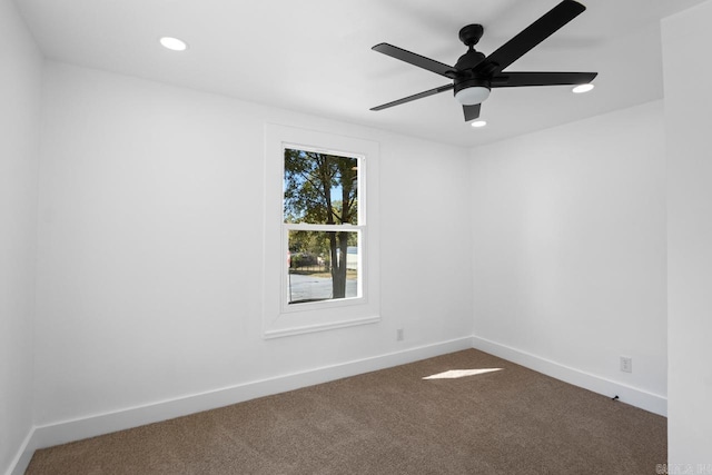 unfurnished room with a ceiling fan, recessed lighting, dark carpet, and baseboards