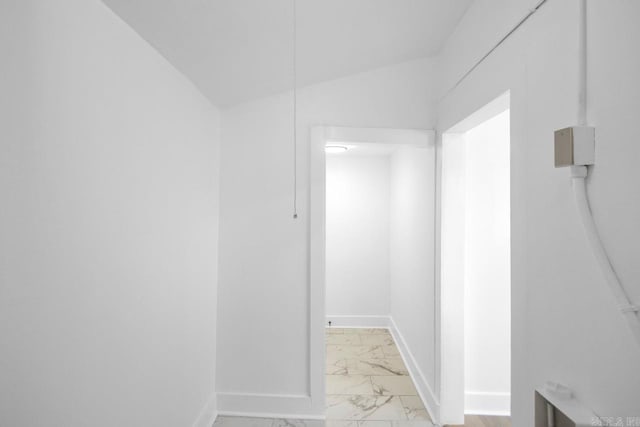 hall featuring marble finish floor and baseboards