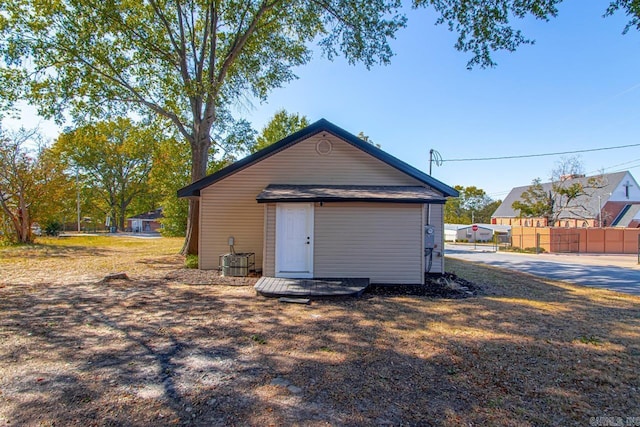 view of outbuilding with fence