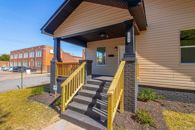 view of exterior entry featuring covered porch