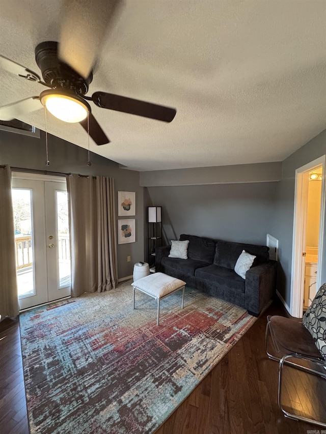 living room featuring a textured ceiling, french doors, wood finished floors, and a ceiling fan