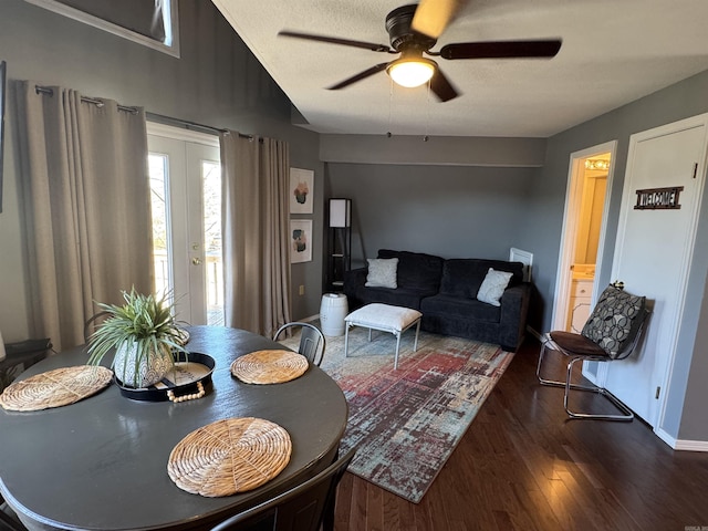 dining area with a textured ceiling, wood finished floors, a ceiling fan, and baseboards