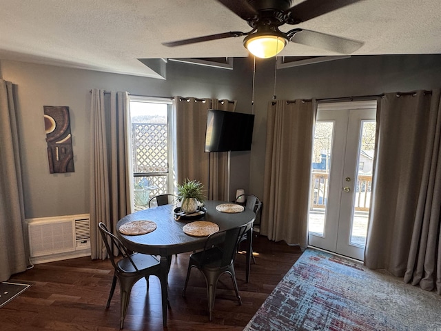 dining area with dark wood-type flooring, french doors, visible vents, and a textured ceiling