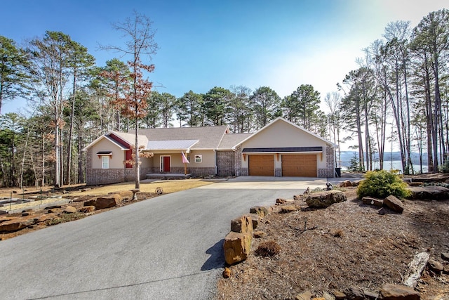 ranch-style house with a garage and driveway