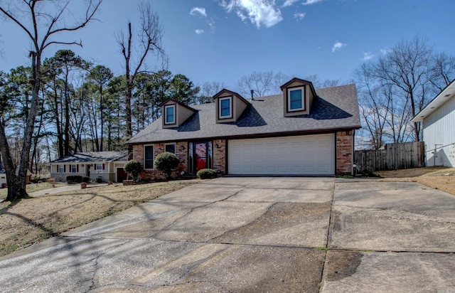 cape cod home with brick siding, roof with shingles, concrete driveway, fence, and a garage