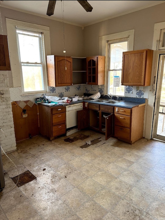 kitchen with open shelves, dark countertops, brown cabinetry, a sink, and dishwasher