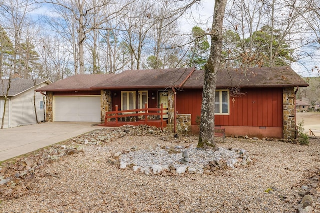 single story home featuring covered porch, concrete driveway, crawl space, a garage, and stone siding