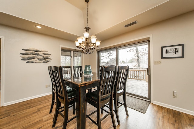 dining space featuring visible vents, baseboards, and wood finished floors