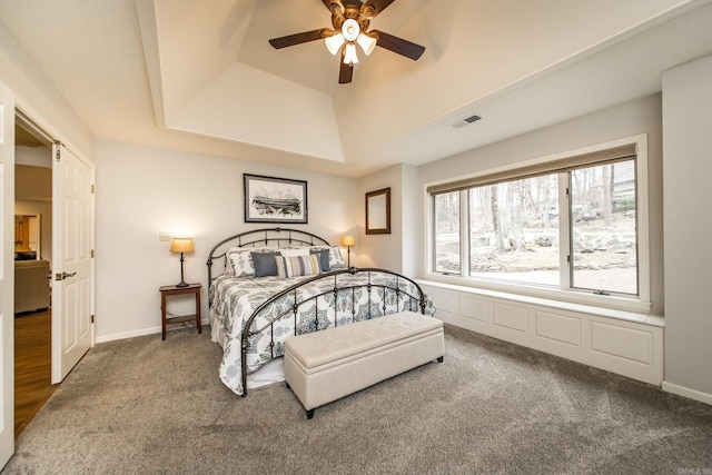 bedroom with carpet floors, baseboards, visible vents, and a raised ceiling