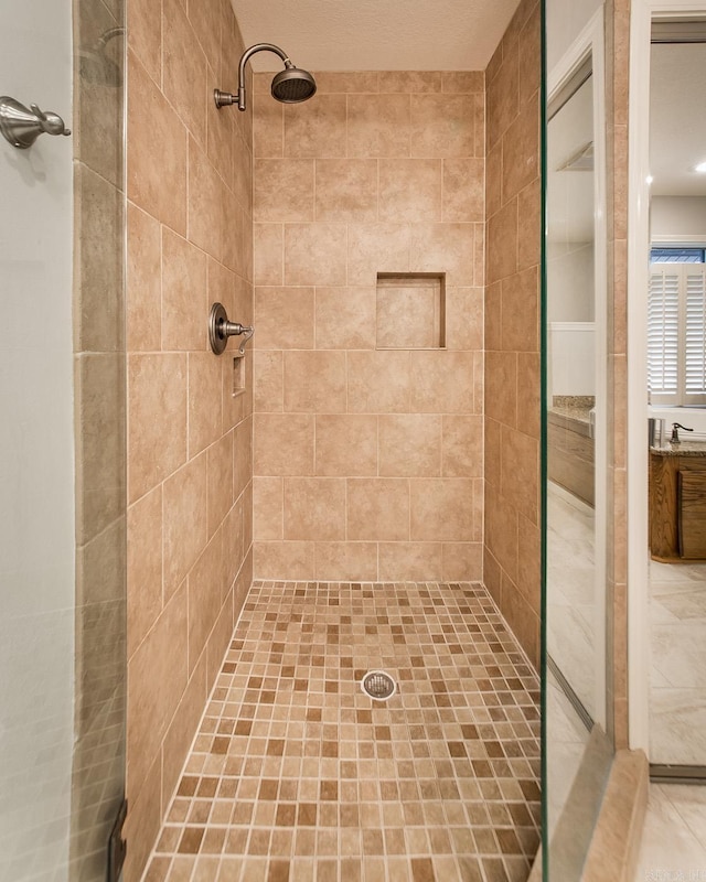 full bathroom featuring a sink and a shower stall